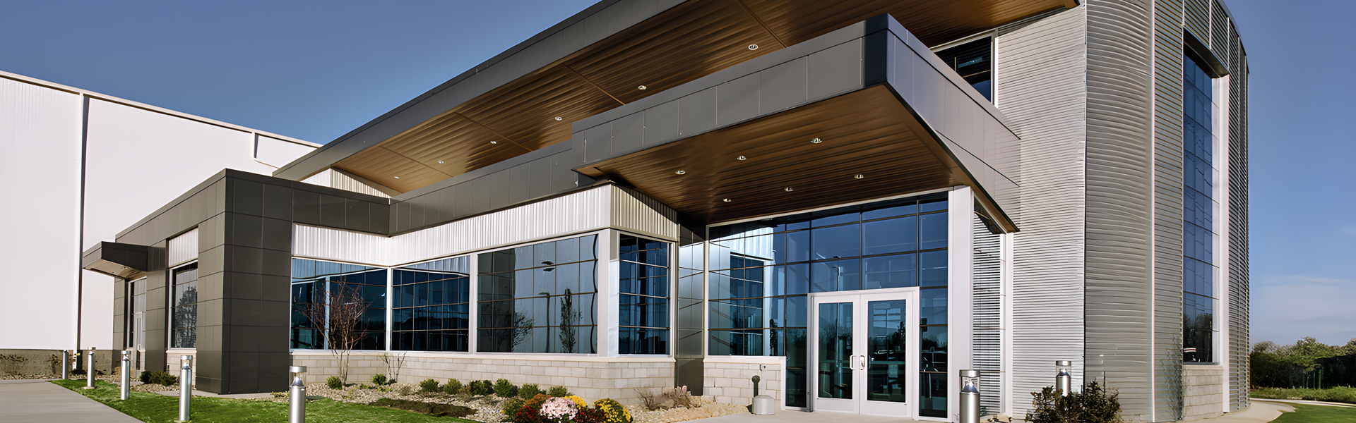Performance Fabrication entry with metal panel accents and a cantilevered canopy with wood soffit